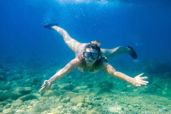 Women diving in the tropical water, snorkeling with mask