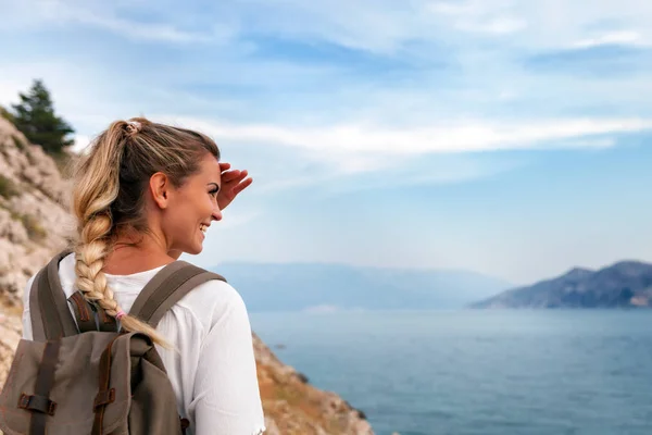 徒步旅行的女孩与背包徒步旅行沿海湾和看风景 — 图库照片