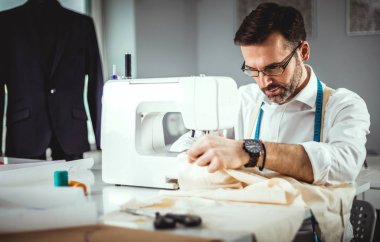 Moda tasarım atölyesinde dikiş makinesi ile terzi lik