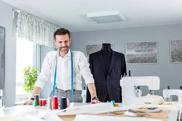 Terzi dükkanı sahibi çalışma masası üzerinde, dikiş atölyesinde zanaatkar