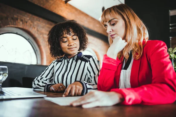 Business meeting at the restaurant, talking about documents