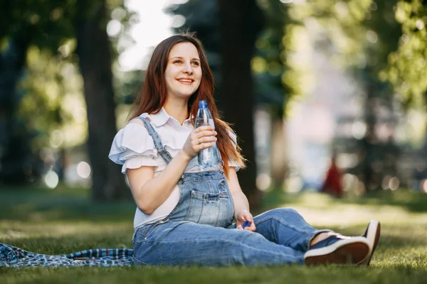 Hamile kadın Park içme suyu dinlenme — Stok fotoğraf