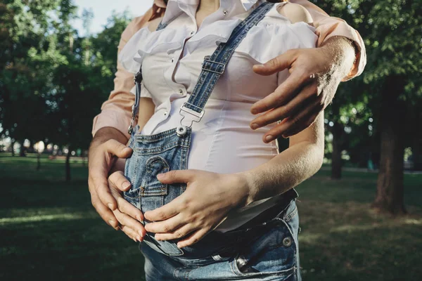 Mother and father hands hugging pregnant belly — Stock Photo, Image