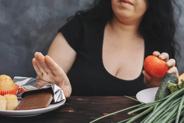 Overweight woman refusing chocolate bar — Stock Photo, Image