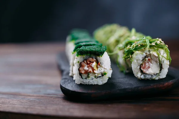 sushi rolls with chuka and green tobiko caviar