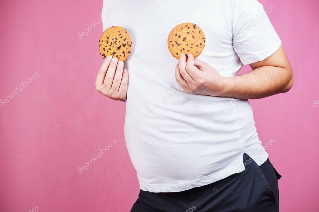 weight gain, hormonal imbalance, man with cookies.