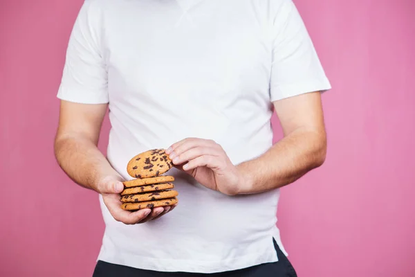sugar addiction, obese man with stack of cookies