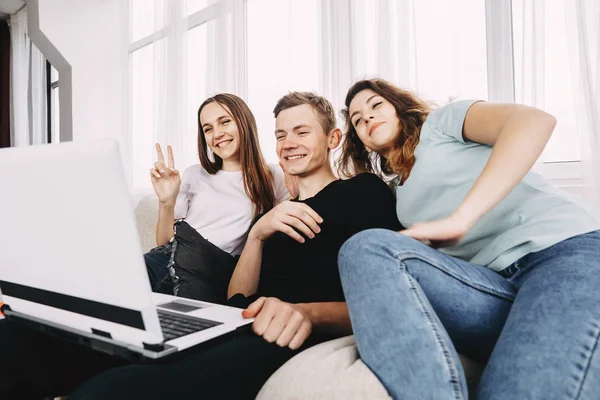 people waving to their  friends during video call