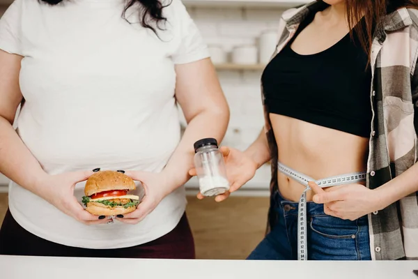 overweight woman with burger and diet pills offer