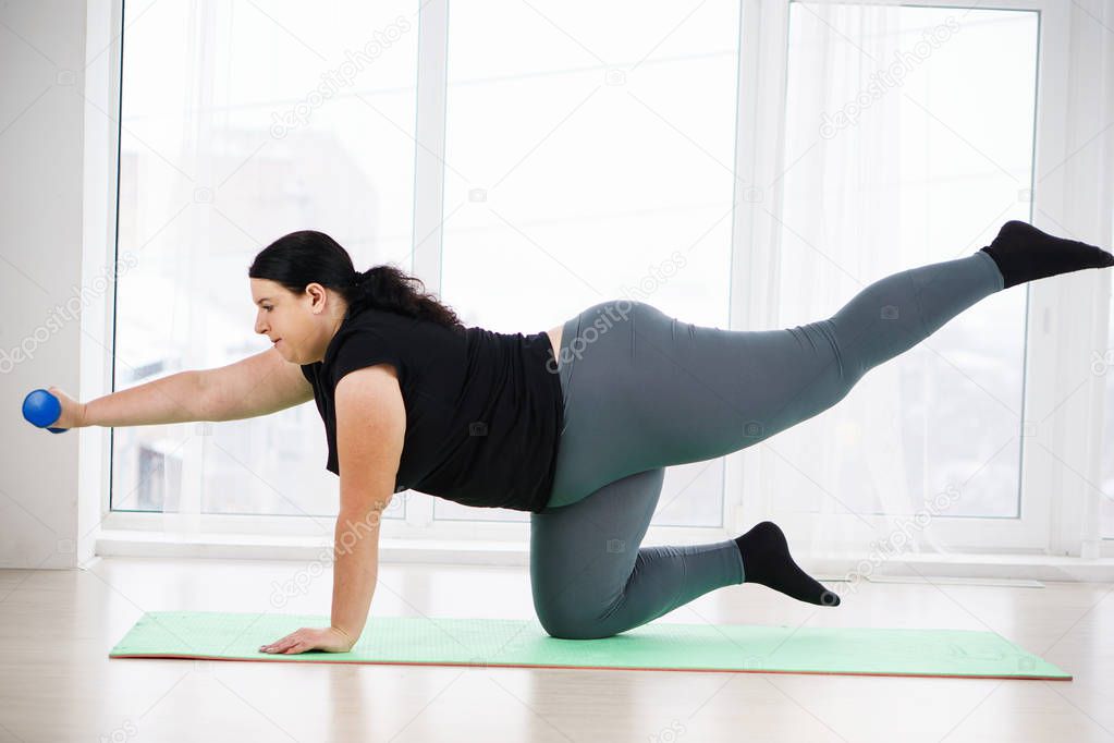 obese woman do isometric exercise during workout