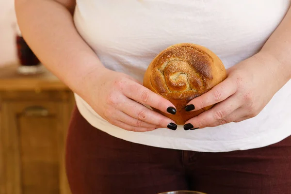 diet breakdown. overweight woman eating pastry