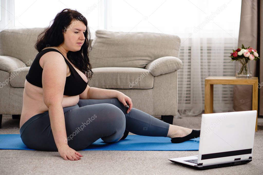 overweight woman rest after yoga workout at home