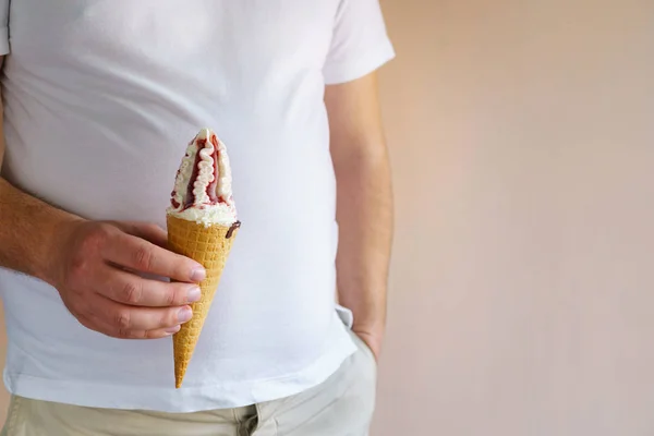 overweight man eating ice-cream. fattening food