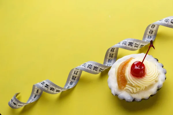 Concept de régime. cupcake sucré et ruban à mesurer — Photo