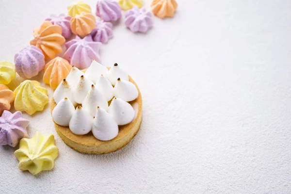 candy background with lemon tart and meringues