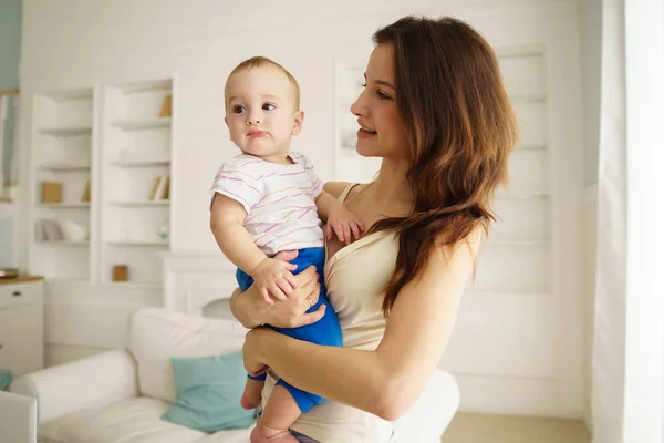 Anne bebek evlat oturma odasında holding — Stok fotoğraf