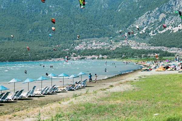 Group of kite surfing on a background of green Turkish mountains. popular sea sport.