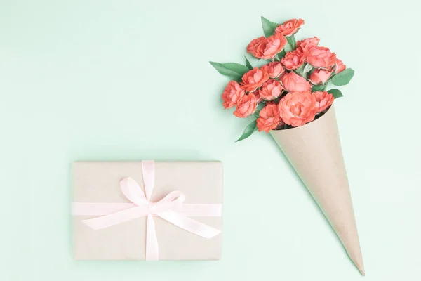 Pink rose flowers, gift box or present on gray stone table