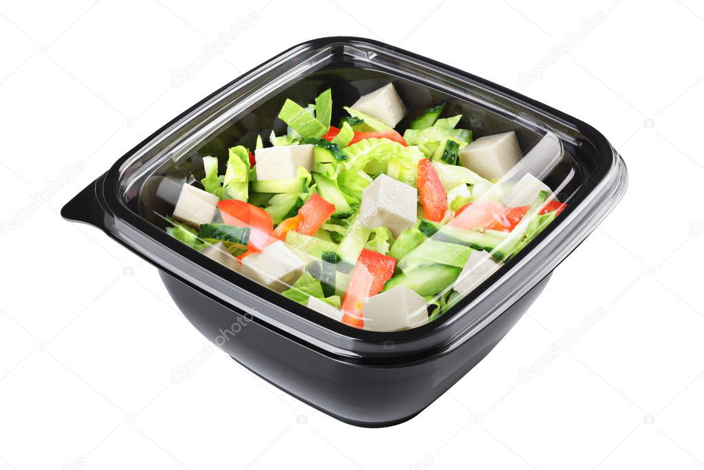 Greek salad in plastic disposable take out container isolated on white background with clipping path