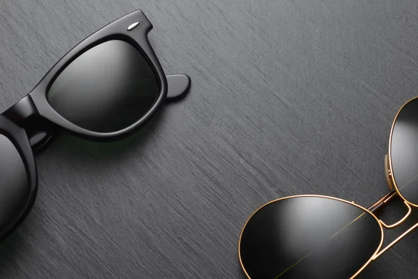 Classic sunglasses on black slate background