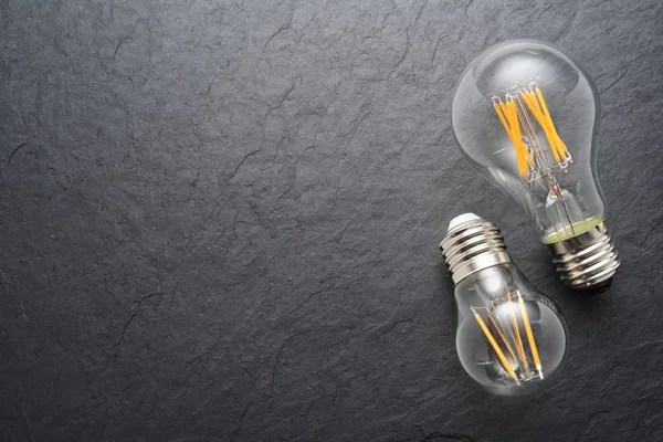 Transparent LED filament light bulbs on black background — Stock Photo, Image