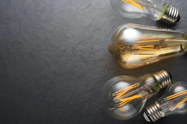 Transparent LED filament light bulbs on black background. — Stock Photo, Image