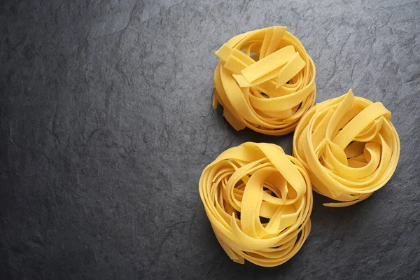Fettuccine pasta on black background — Stock Photo, Image