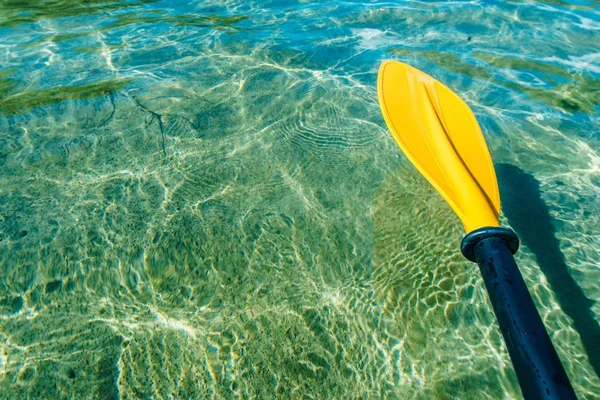 Kayak Paddle Water Sports Theme. Crystal Clear Lake Water and the Paddle.