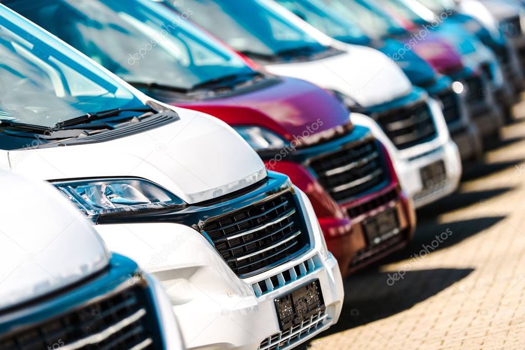 Cargo Vans Dealer. Row of Brand New Modern Commercial Vehicles For Sale.