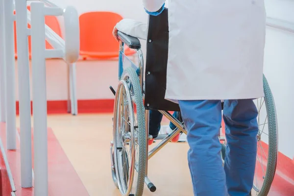 Child on the Wheelchair in the Hospital Hall. Healthcare Theme.