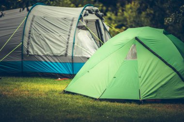 Summer Vacation Camping in a Tent. Campsite with Two Large Tents. clipart