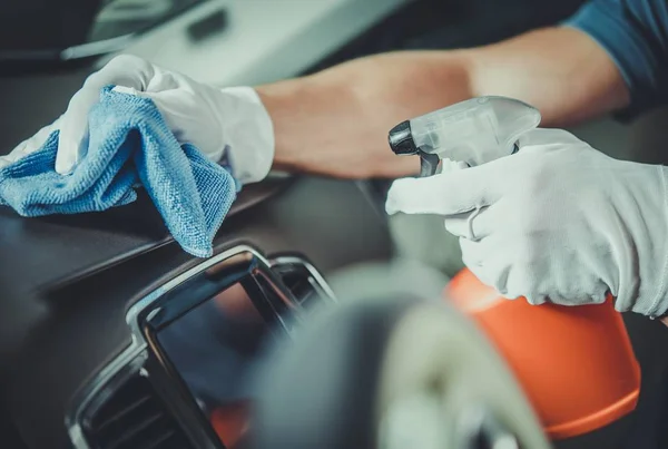 Arbeiter putzt Armaturenbrett im Auto — Stockfoto