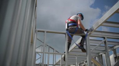 Amortisör Lanyard ve Emniyet Kemeri Ekipmanları. Yükseklik Güvenliği'nde çalışın. Çelik Yapı Çerçevesi Üzerine Kafkas Yüklenicisi.