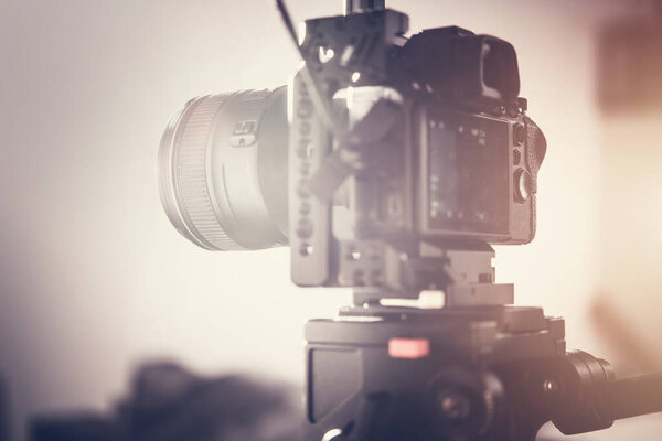 Modern Full Size Sensor Digital Camera on a Tripod. Taking Short Video Clips For Documentary Film Production. 