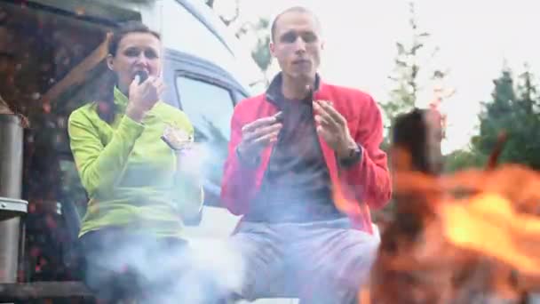 Pareja Caucásica Disfrutando Comida Aire Libre Frente Fogata Comiendo Salchichas — Vídeo de stock