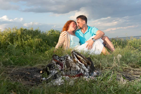 Couple on a picnic. Picnic for couple before rain. happy couple in love at a picnic with bonfire. young couple in love having fun and enjoying nature