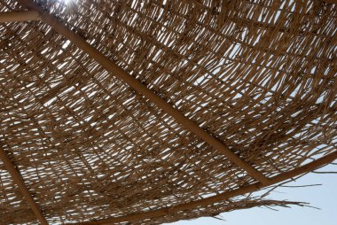 Örgülü şemsiyeleri kapatın. Güneş plaj şemsiyesi rattan kubbe ile. Yaz güneşte örgülü şemsiye kubbe. Örgülü şemsiye closeup arka plan.