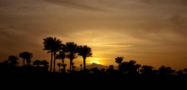 Günbatımı takoz avuç içinde. Avuç içi ile kış akşam. Aşağı sarı güneş ve gökyüzü.