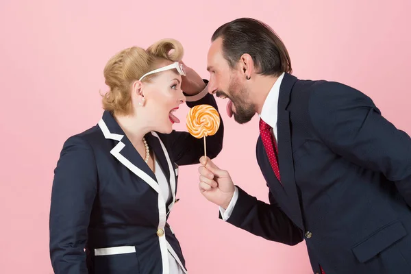 lollipop in danger. two managers fighting for one candy. face to face crying with open mouths and tongues.officers fight for one lollipop. Man vs woman eye to eye