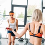 Three multicultural sportswomen training at gym