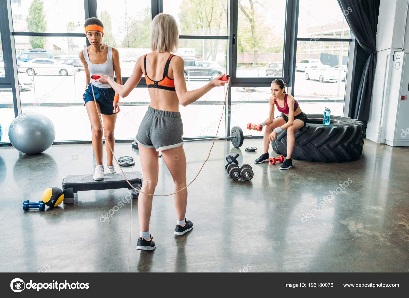 Rear View Sportswoman Doing Exercise Jump Rope African American Female Stock Photo SashaKhalabuzar 196180076
