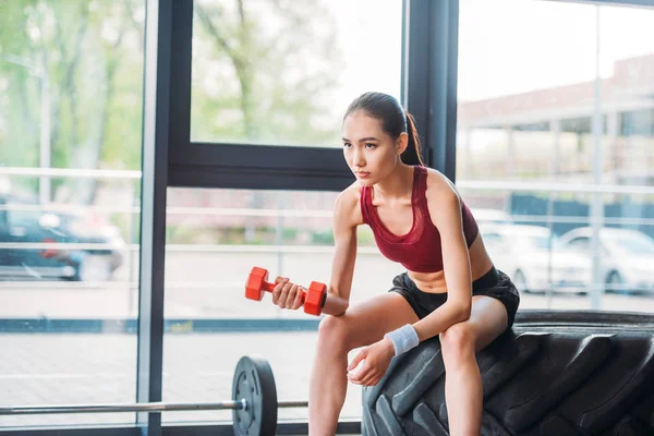 Asian Female Athlete Dumbbell Sitting Training Tire Gym — Stock Photo, Image