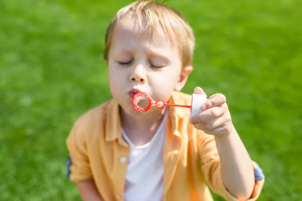 Cute Little Boy Closed Eyes Blowing Soap Bubbles Park — Free Stock Photo