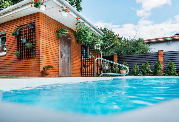 selective focus of swimming pool on country house yard