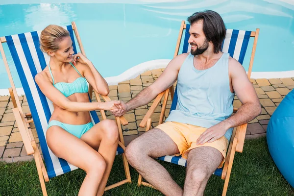 Couple Beach Chairs Holding Hands While Spending Time Swimming Pool — Stock Photo, Image