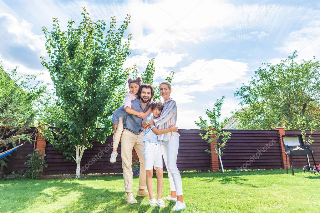 happy family with labrador dog on backyard on summer day