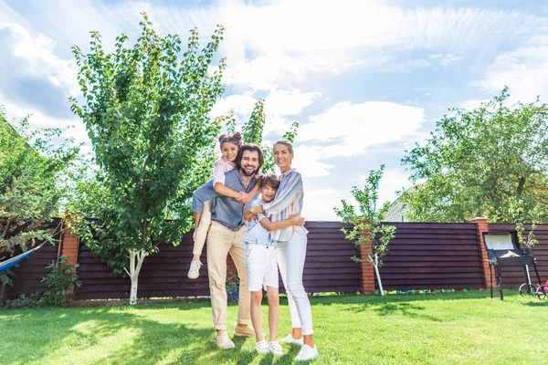 Happy family with labrador dog on backyard on summer day — Stock Photo