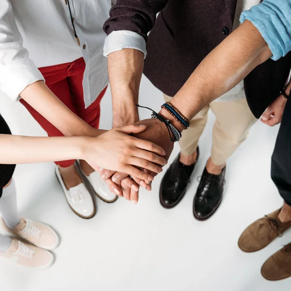 Partial view of friends stacking hands together — Stock Photo