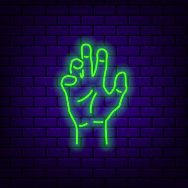 Koyu tuğla arka plan neon zombi el simgesi.