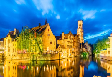 Canal in Bruges and famous Belfry tower in Brugge, Belgium. clipart